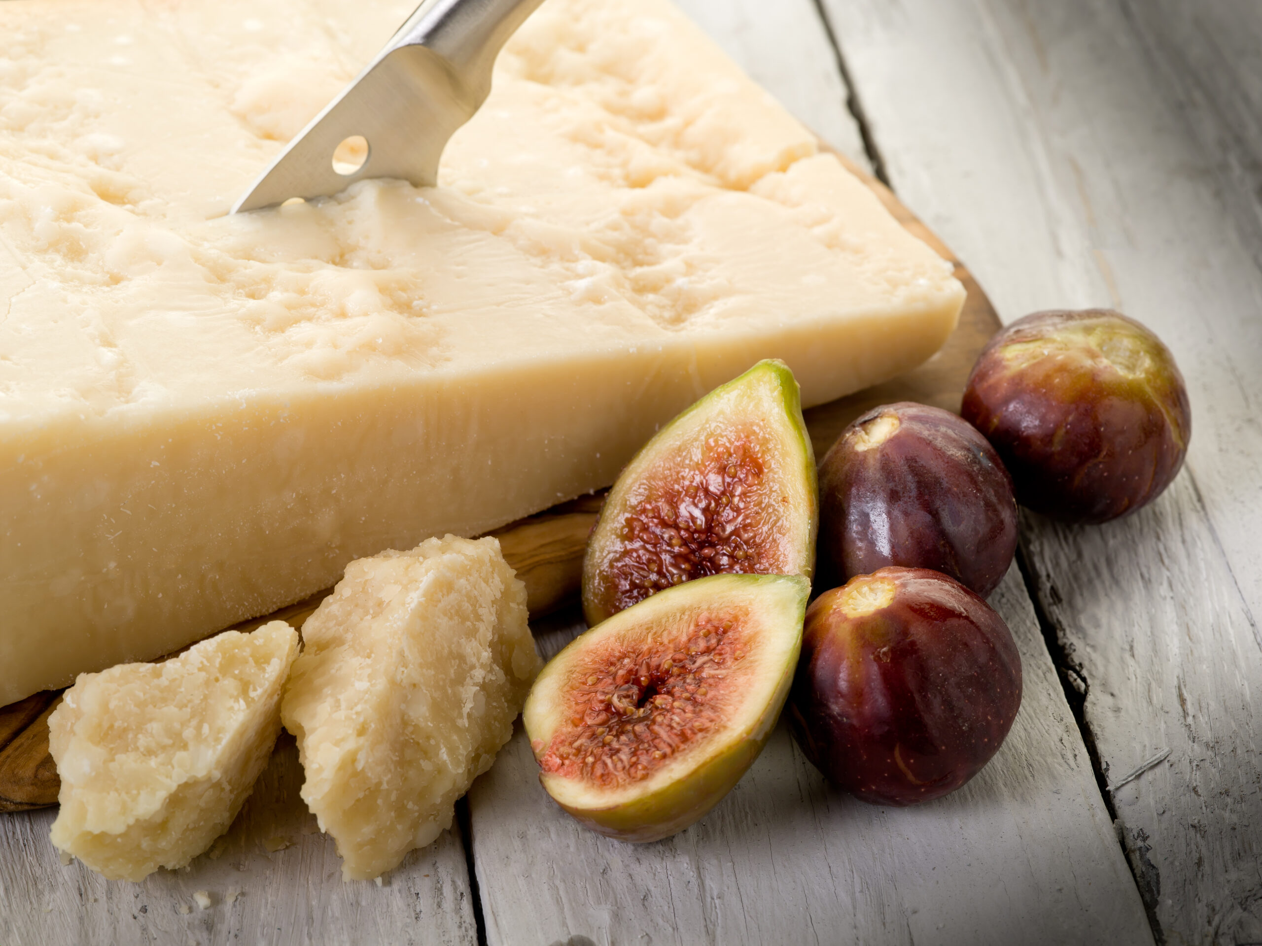 a wedge of Parmigiano Reggiano with fresh figs
